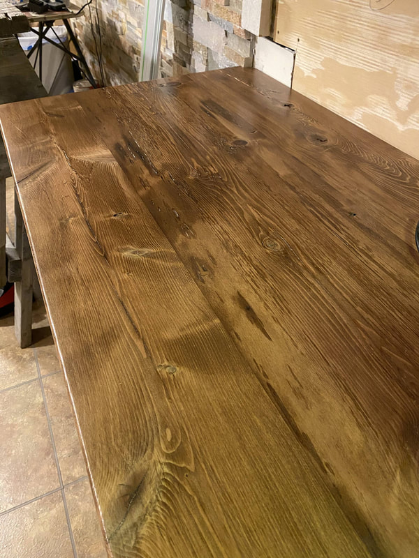 Close‑up of reclaimed barn‑wood countertop surface, showing natural grain and handcrafted finish.