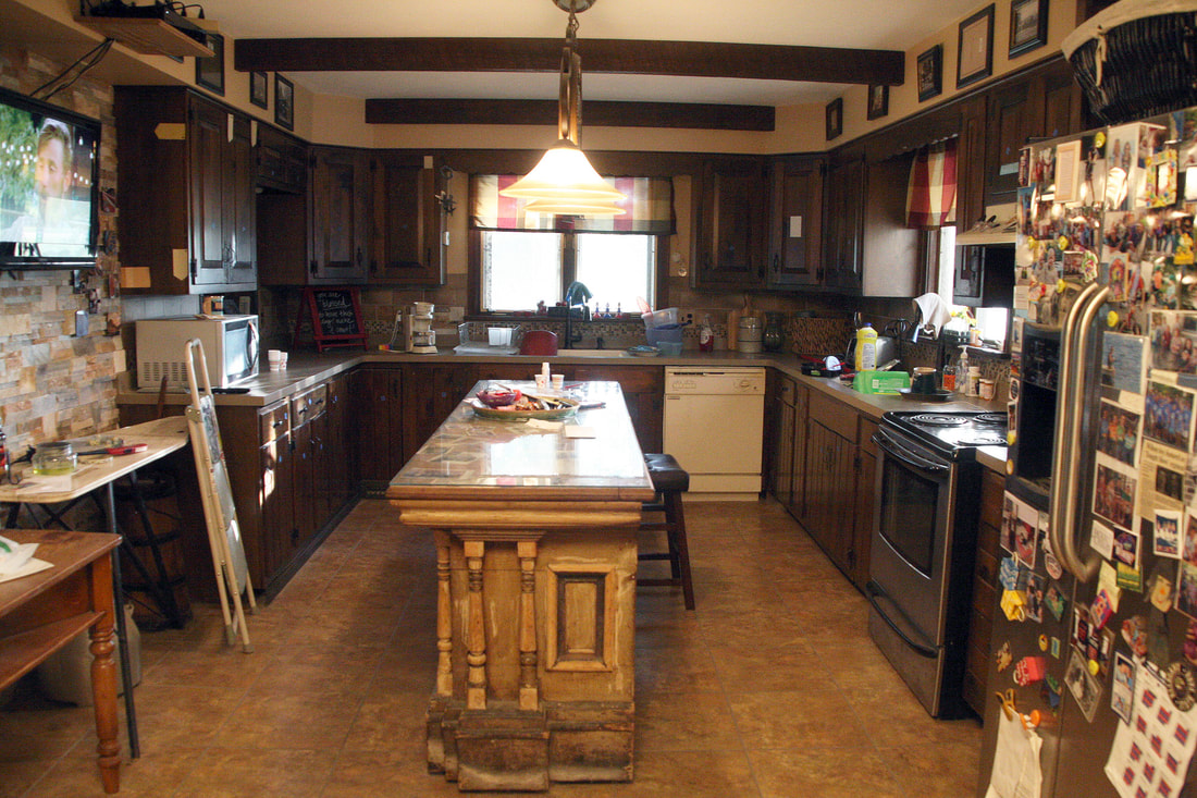 “Original kitchen before remodel, featuring dark cabinets, central island, and lived‑in family layout prior to renovation