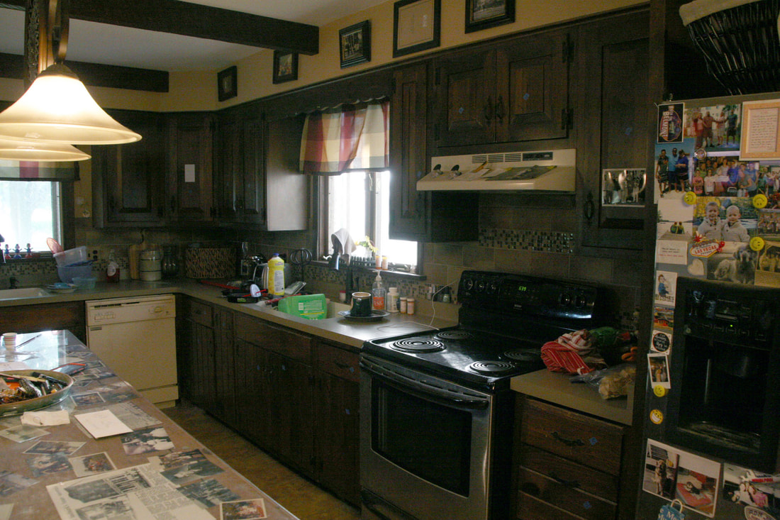 Original kitchen before remodel, featuring dark wood cabinets, central island, and lived‑in family layout prior to renovation.